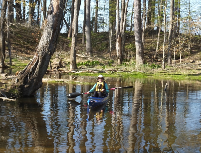 Norma smiling in her kayak