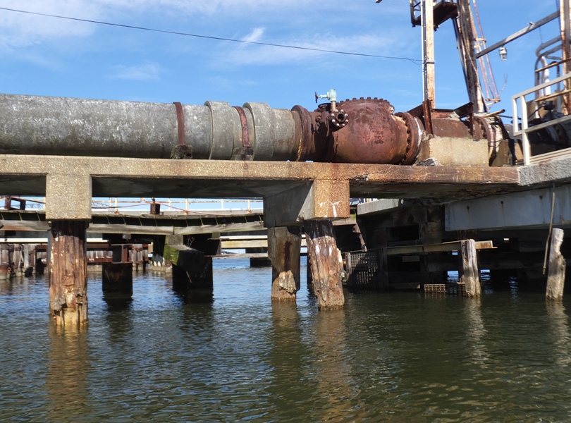 Elevated old pipe on concrete and wood risers