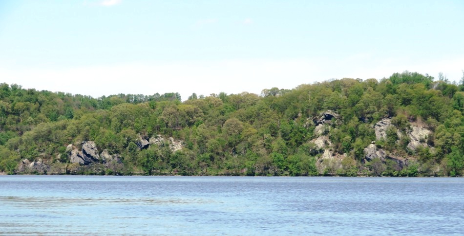 Rock formations and trees across the reservoir