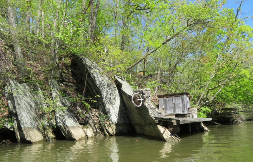 Pier by big rocks with bicycle tire mounted to one rock