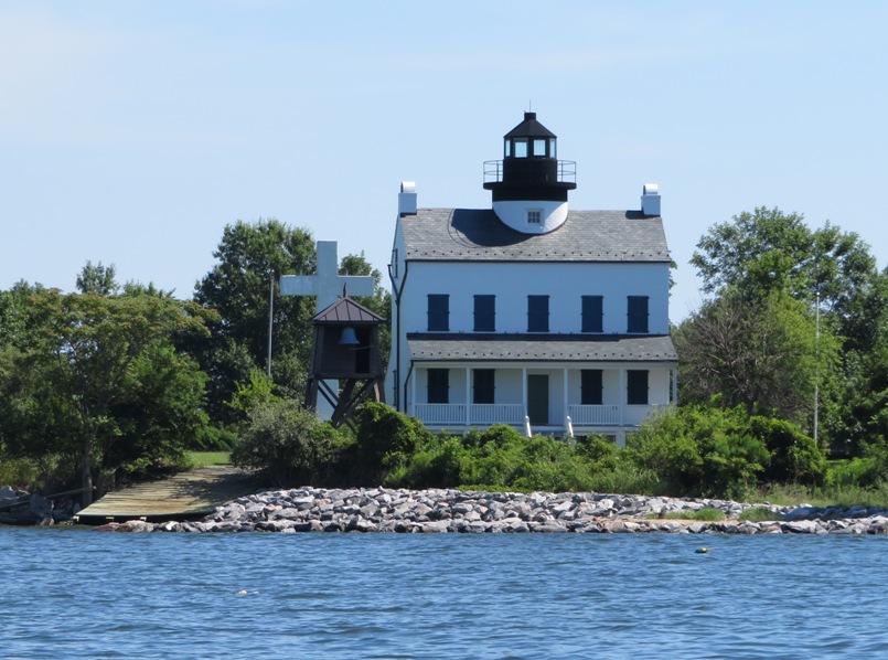 View of lighthouse, bell tower, and cross