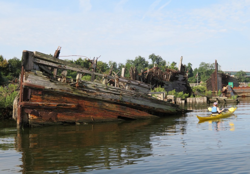 Sara kayaking by shipwreck