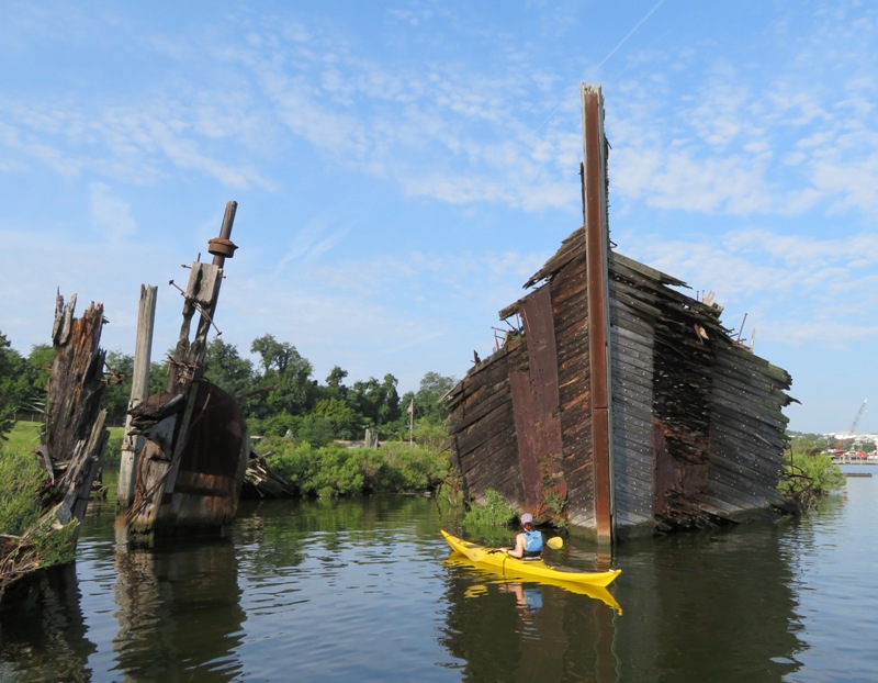 Sara looking at shipwreck standing high in the water