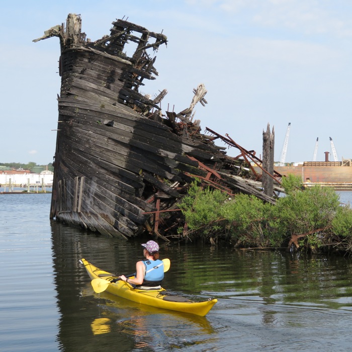 Sara in front of shipwreck showing charring