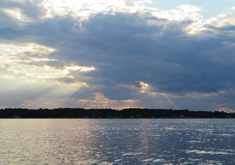 Sun shining down through clouds