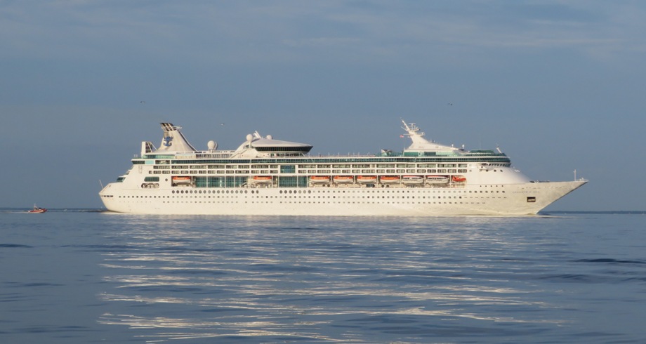 Luxury cruise ship and small powerboat