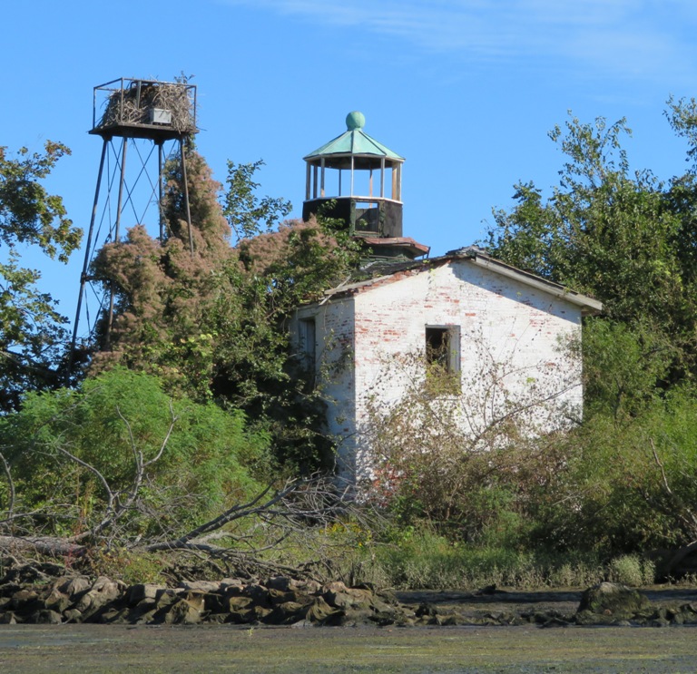 Lighthouse, white building, and tower