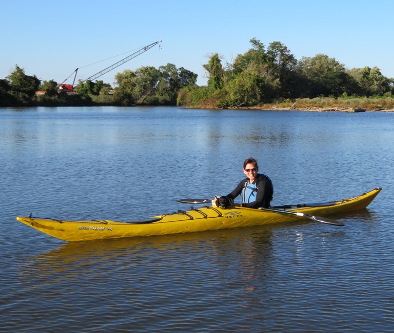 Sara and Cassi in the kayak, facing me with a construction crane in the background