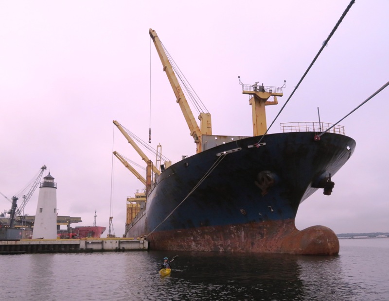 Lazaretto Lighthouse, Sara in her kayak, and a large ship