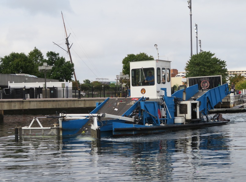 Blue and white trash collecting boat