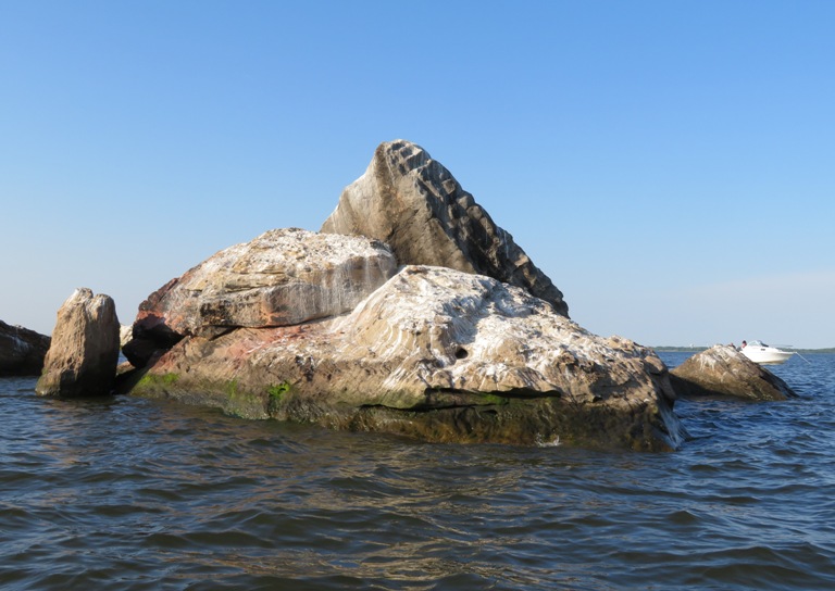The top side of the rocks are white from bird poop