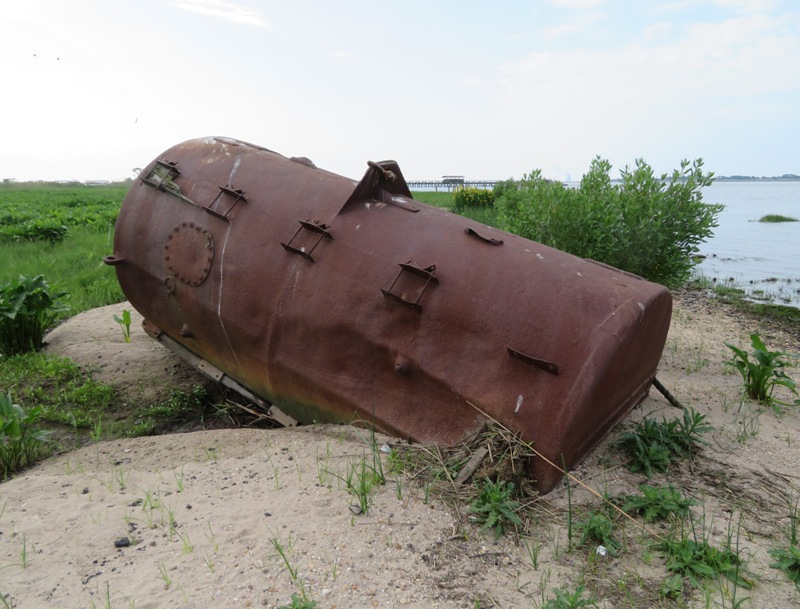 Rusty metal cylinder on beach