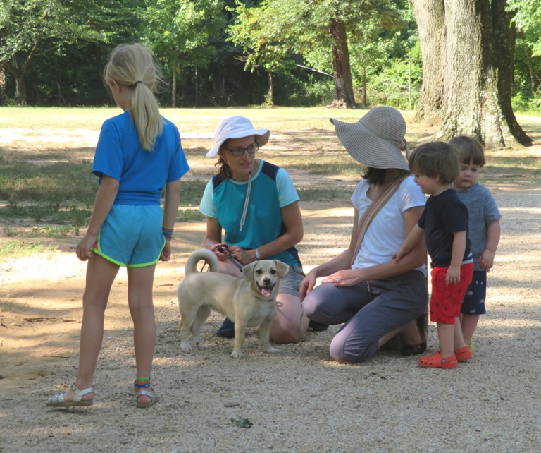 Norma talking to woman, Daphne, and children