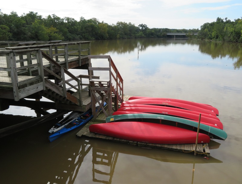 Our kayak and SUP parked under the stairs with lots of canoes on the pier