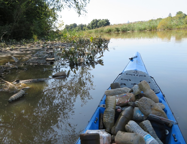 Trash in water and trash on Norma's boat