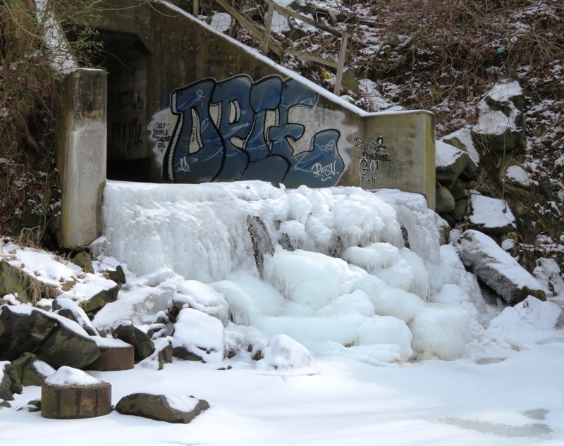 Ice at graffiti-covered culvert