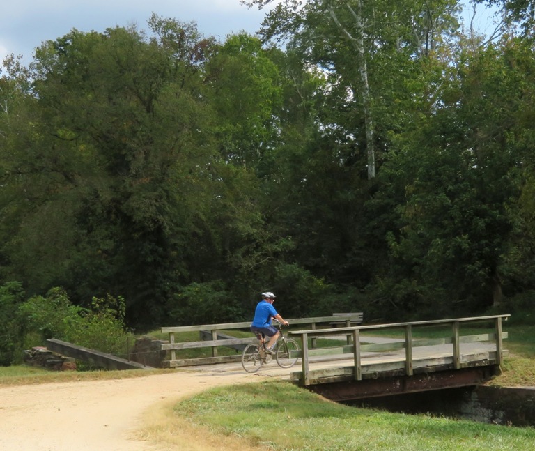 Bicyclist on bridge over canal