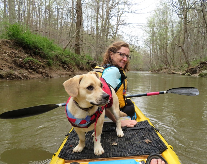 Norma in the front seat of the kayak with Daphne behind