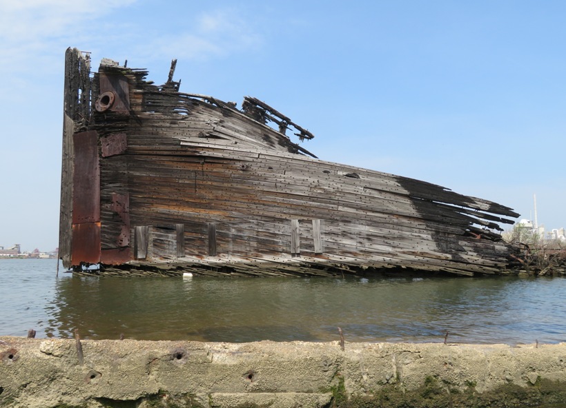 Portside view of shipwreck sticking out of water