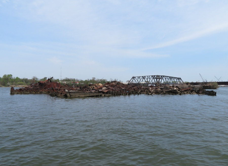 Imploded shipwrecks with swinging train bridge behind
