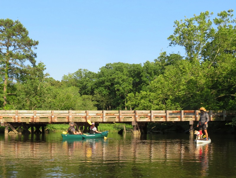 Sara and Mike in canoe with Daphne and me on SUP with Kingston Road bridge behind