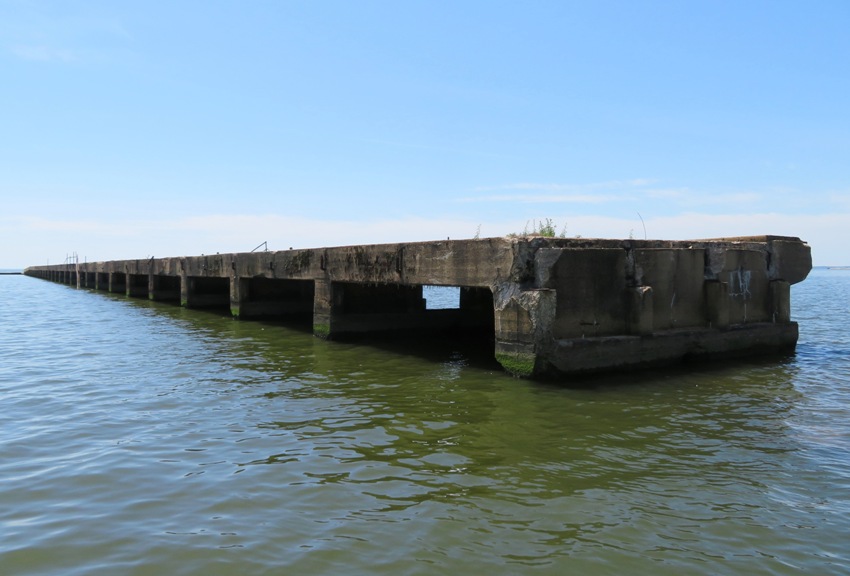 Southeast view of concrete dock leading to the concrete ships