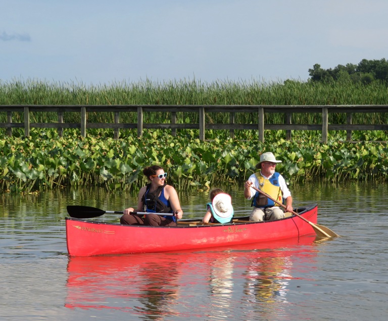 Blythe A. and Bob in canoe with child between them