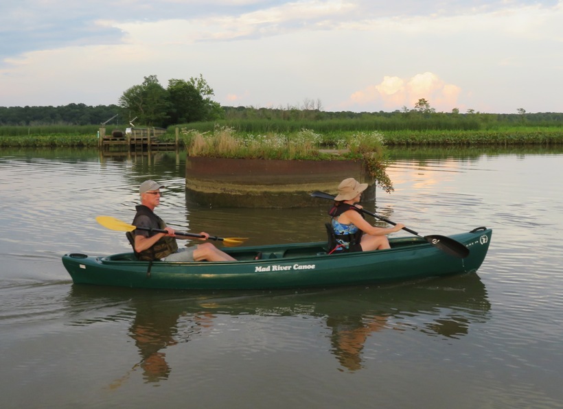 Sara and Mike paddling in front of old train bridge support