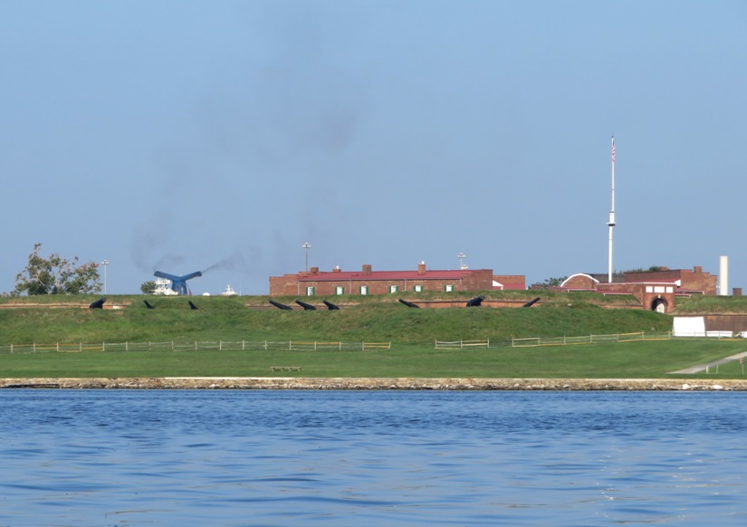 Fort McHenry with several small cannons and what appears to be a large smoking cannon pointed towards Baltimore