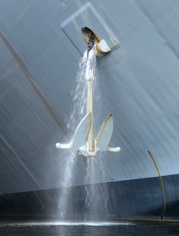 Water pouring out of a ship where the anchor is attached