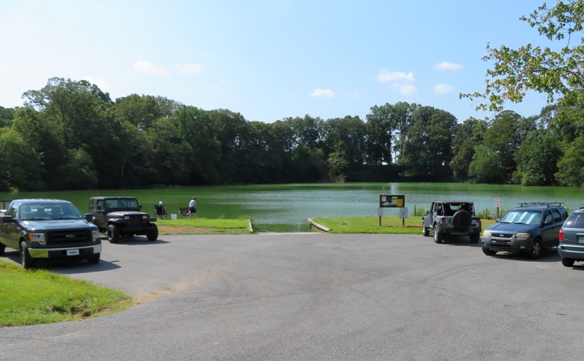 Parking lot, several vehicles, and larger ramp for launching