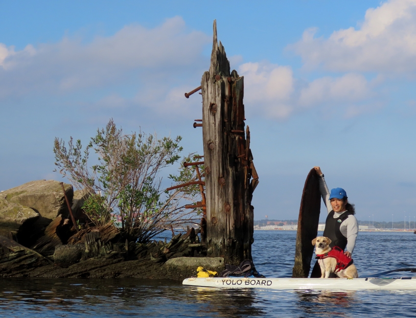 Daphne on SUP with me standing on propeller spindle behind her