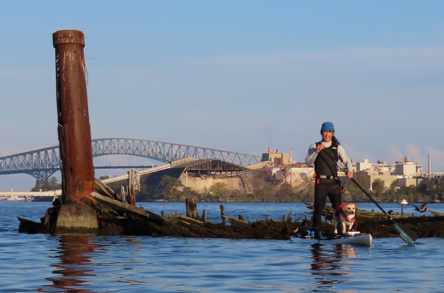 Daphne and I on SUP next to wreck with Key Bridge in background