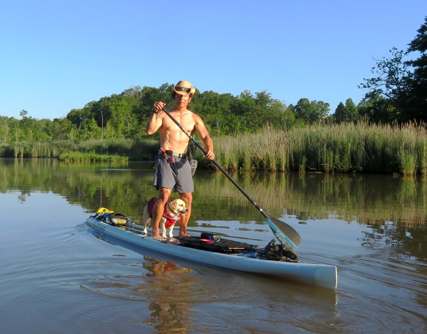 Me on SUP shirtless with Daphne standing between my legs