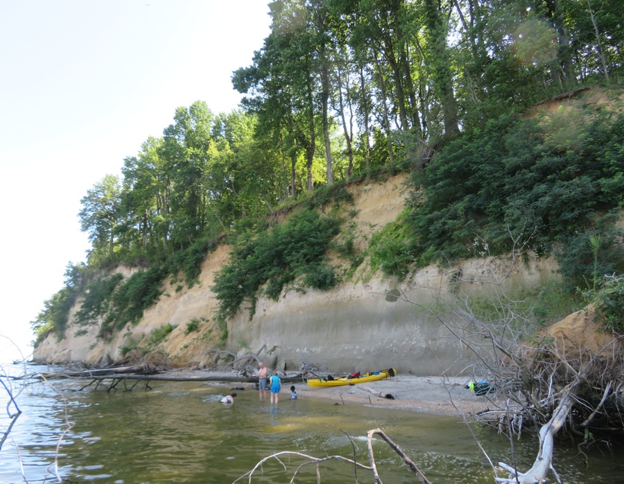 Sara, Mike B., Norma, and her niece in shallow water by a cliff