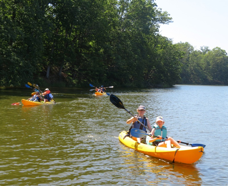 Allison and her daughter kayaking with others behind
