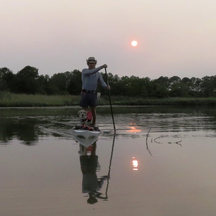 Daphne and me on SUP with hazy sun behind