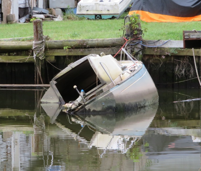 Small boat with open port that might have let water in