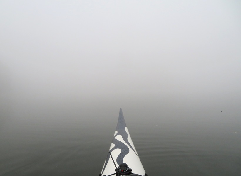 Bow of surf ski with thick fog