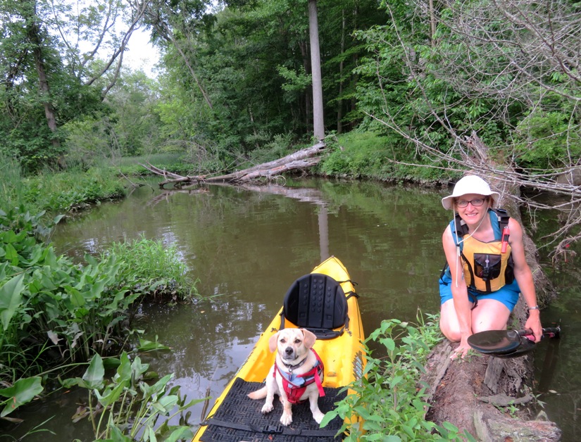 Norma on log with Daphne on kayak