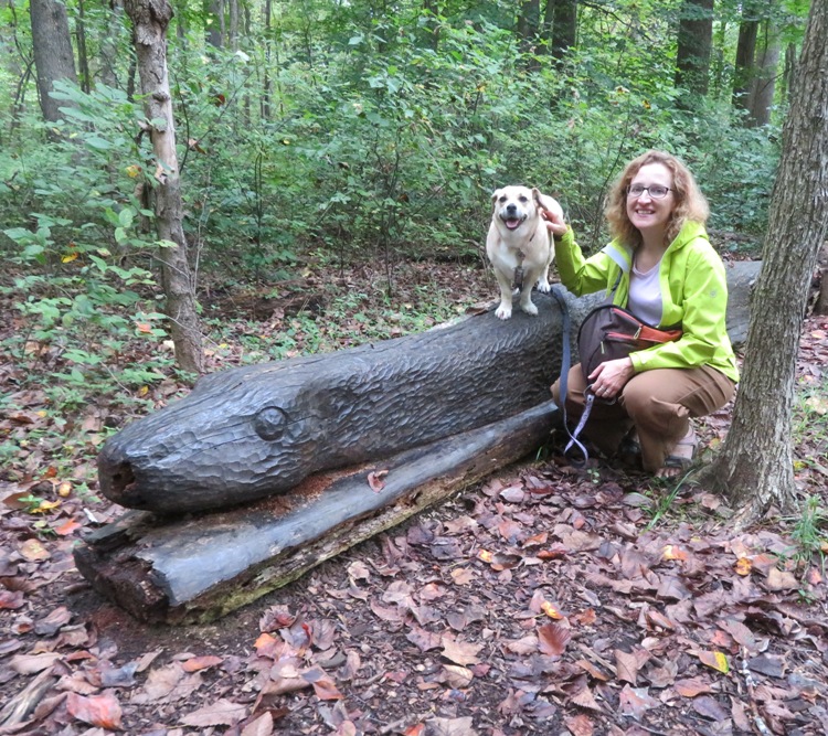 Norma and Daphne at a wooden snake sculpture carved out of a log