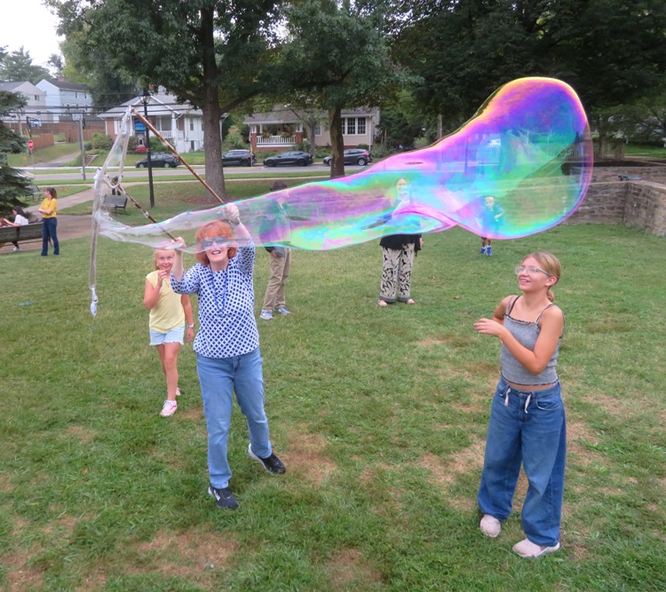 Kid watching the bubble and not trying to pop it