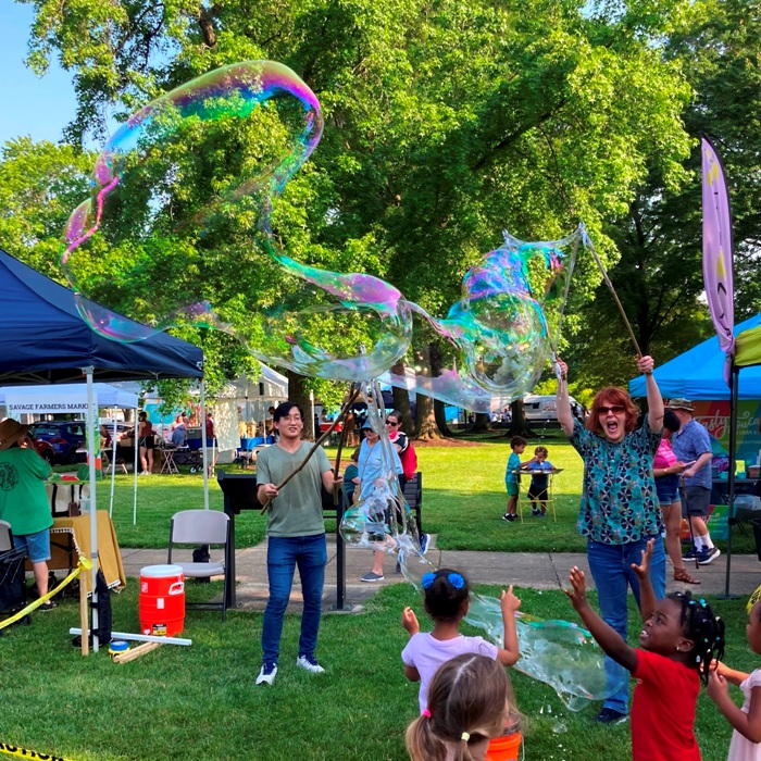 Woman bubble maker with mouth open, showing excitement