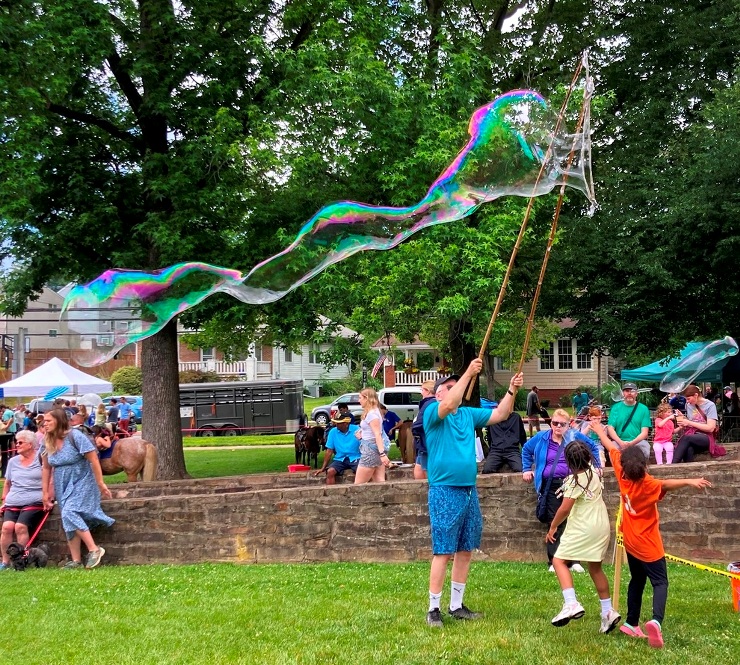 Making a long bubble with the medium-sized wand