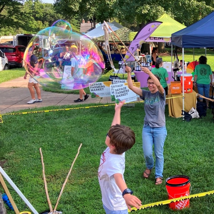 Woman making bubble inside a bubble