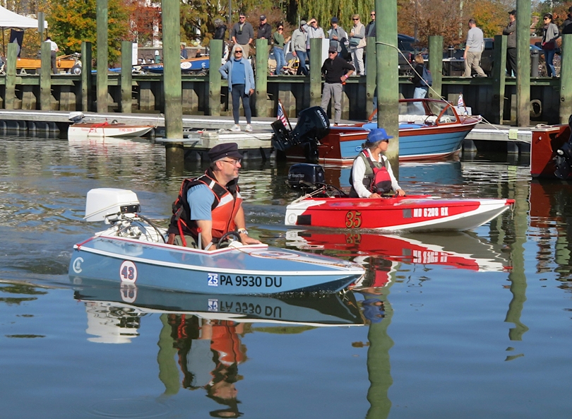 Man and woman, each driving cocktail class racing boats