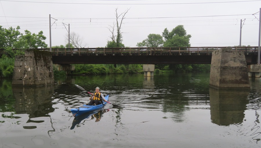 Norma in kayak near bridge and old bridge footing