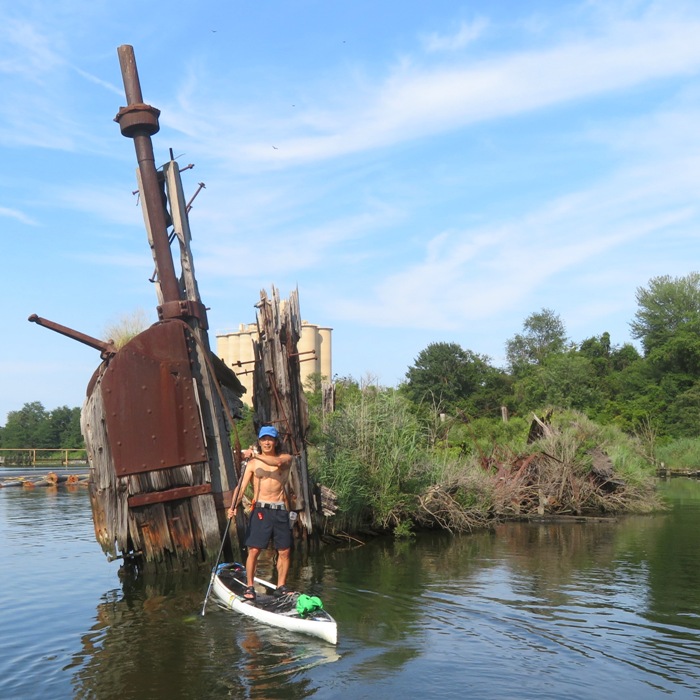 Me on SUP in front of shipwreck rudder