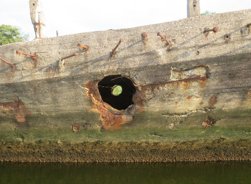 Looking through two portholes of concrete boat