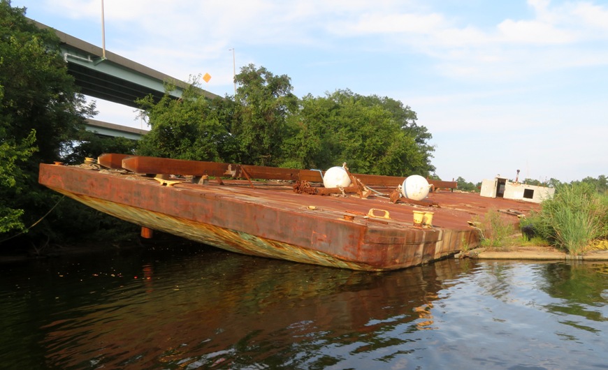 Tilted, rusty steel barge